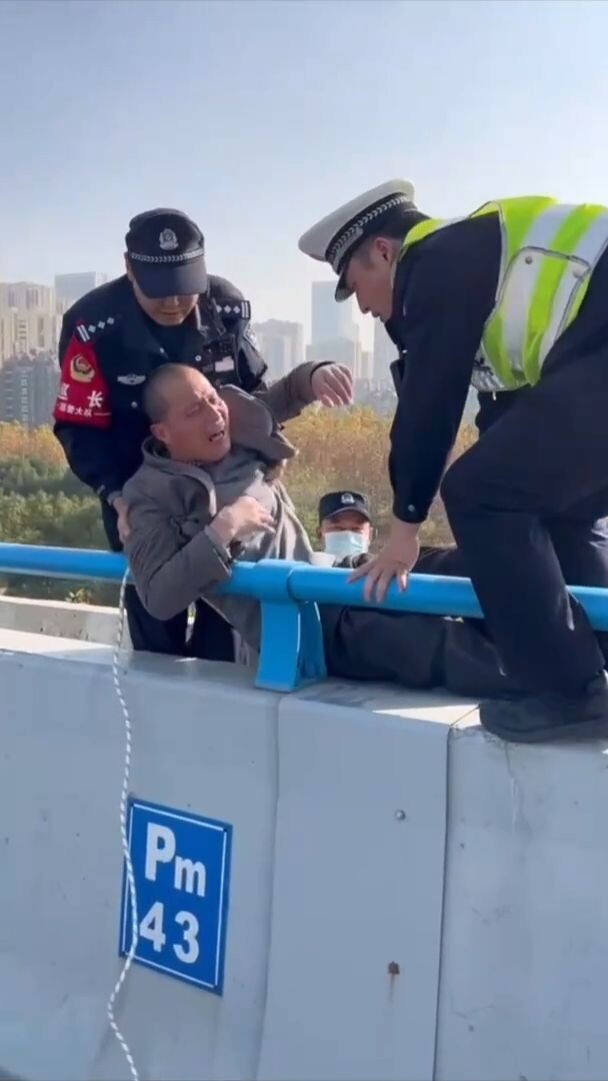 ตำรวจจีนช่วยชีวิตชายคิดโดดตอม่อทางยกระดับ