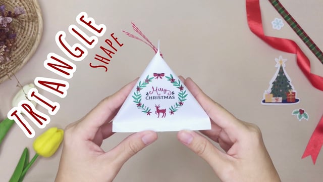 ▶️คลิป : How to Wrap Gift in Triangle Shape: วิธีทำถุงของขวัญสามเหลี่ยมสำหรับห่อของขวัญปีใหม่